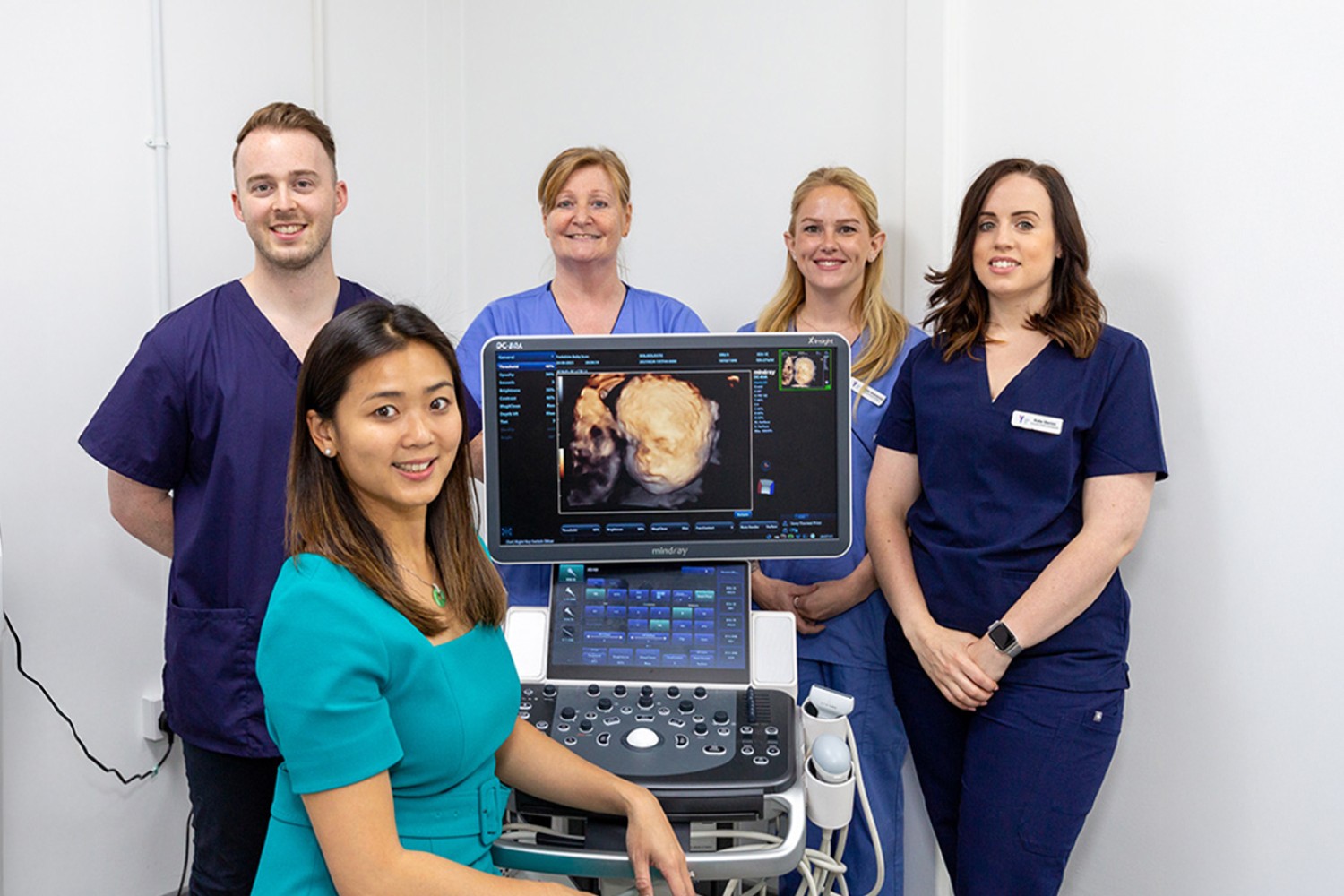 Yorkshire Baby Scan team posing next to an ultrasound scan machine