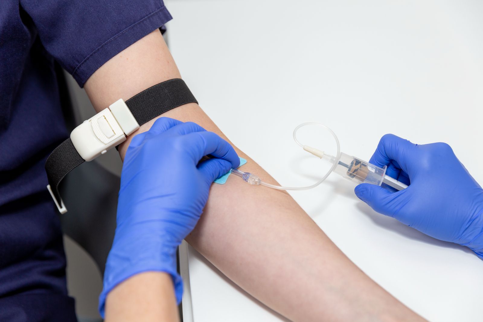 Blood sampling for NIPT test, showing patient’s arm and specialist drawing blood